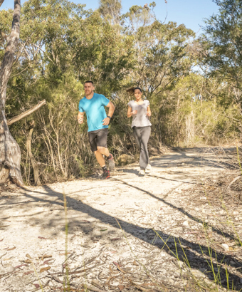 Two people running along a trail in NSW national parks. Credit: John Spencer &copy; DCCEEW