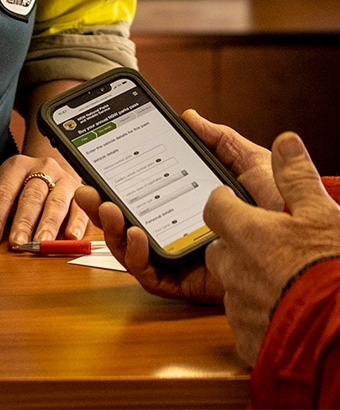An NSW National Parks visitor purchasing their digital parks pass via their smartphone. Photo credit: Murray Vanderveer &copy; DPIE