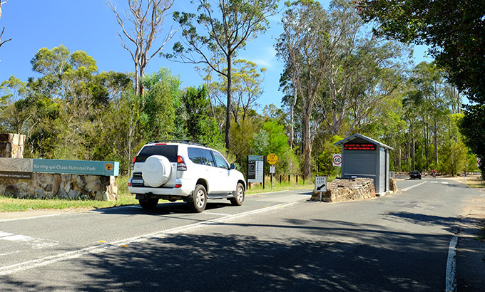 A car passes the park entry booth at Ku-ring-gai Chase National Park. Photo: E Sheargold/OEH