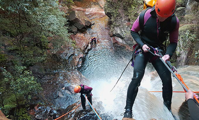 A person roping down a waterfall. Credit: James Waddell &copy; Eagle Rock Adventures