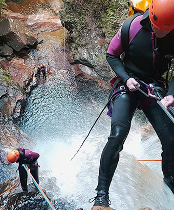 A person roping down a waterfall. Credit: James Waddell &copy; Eagle Rock Adventures