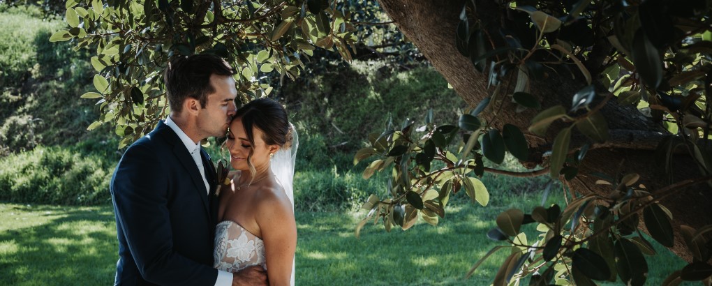 A newlywed couple pictured amongst the lush green surrounds at Sydney Harbour National Park. Photo: Matthew Horspool © DPIE