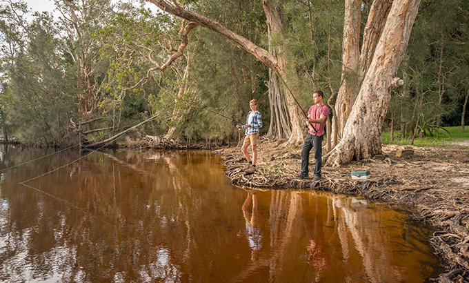 Two men fishing at Mungo Brush campground, Myall Lakes National Park. Photo: John Spencer/DPIE