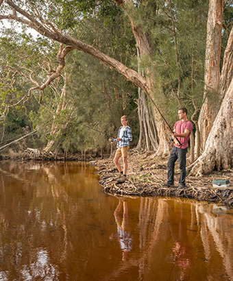 Two men fishing at Mungo Brush campground, Myall Lakes National Park. Photo: John Spencer/DPIE