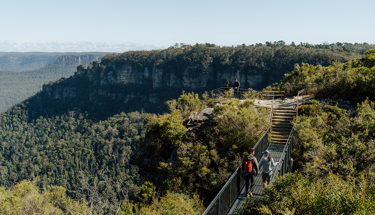 2 walkers crossing Buttenshaw Bridge on Grand Cliff Top Walk. Photo: Remy Brand &copy; Remy Brand.