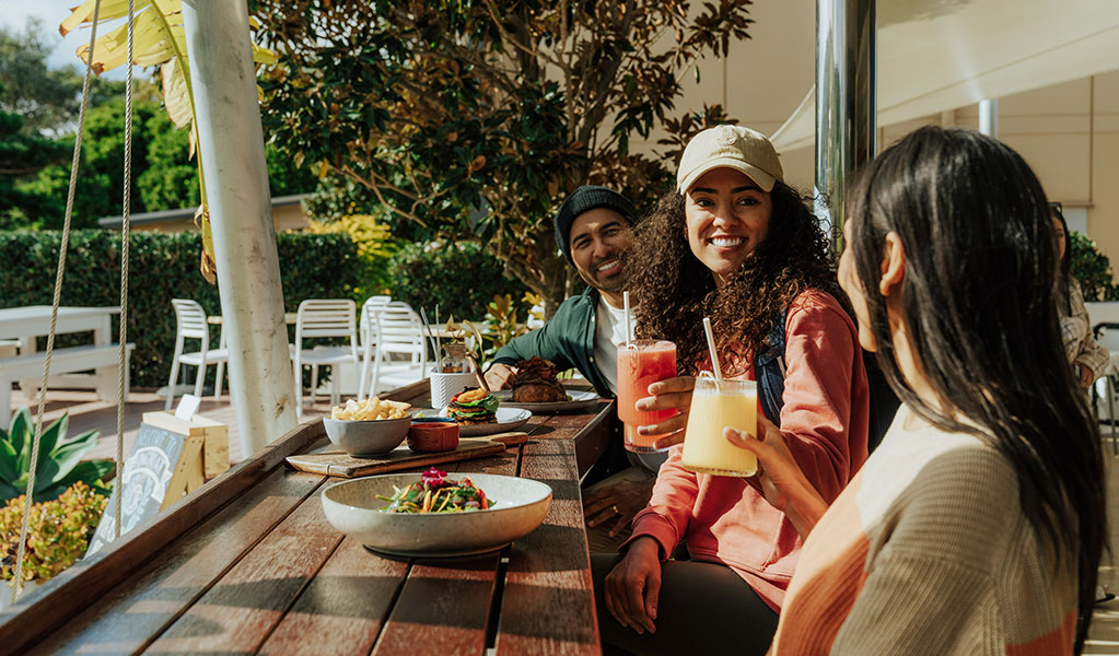 Walkers enjoy lunch and drinks at a cafe in Fingal Bay on the Tomeree Cosatal Walk. Credit: Remy Brand &copy; Remy Brand