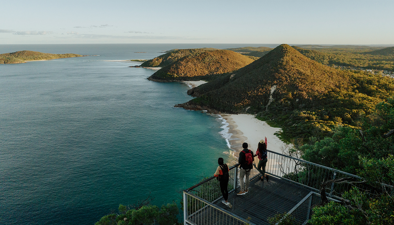 Walkers admire coastal views and islands from the lookout at Tomeree Head Summit along Tomaree Coastal Walk. Credit: Remy Brand &copy; Remy Brand