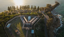 Aerial view of Trial Bay Gaol and the waterfront campsites. Credit: Glen Ellis &copy; DCCEEW
