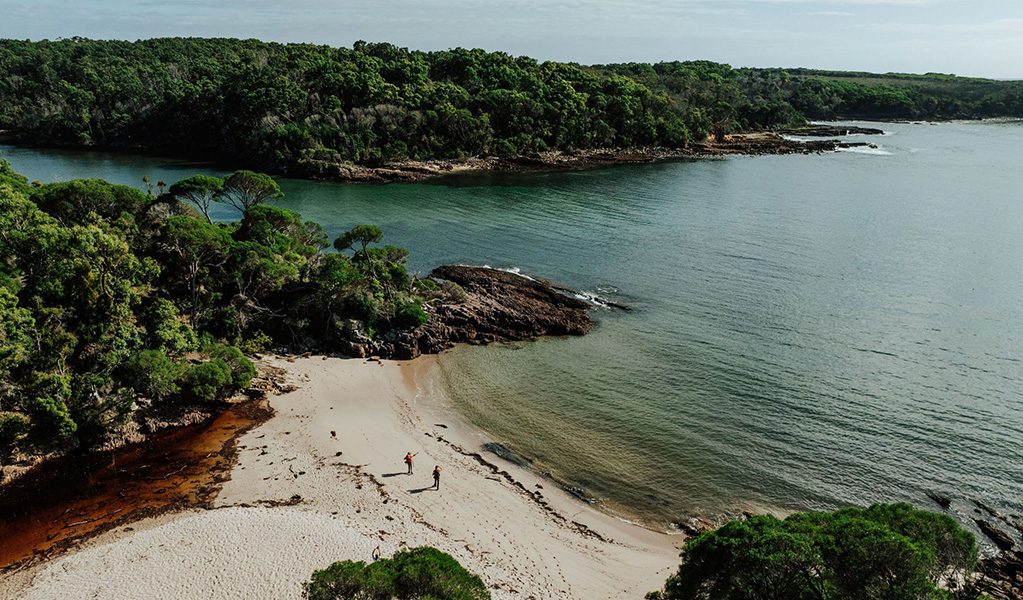 Aerial view of 2 hikers at Bittangabee Bay in Beowa National Park. Credit: Daniel Parsons/DCCEEW &copy; Daniel Parsons