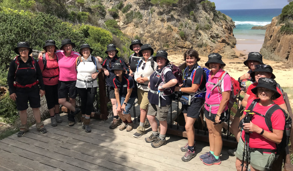 Group of women wearing bucket hats posing for photo in front of beach in Beowa National Park. Photo: &copy; Life's An Adventure
