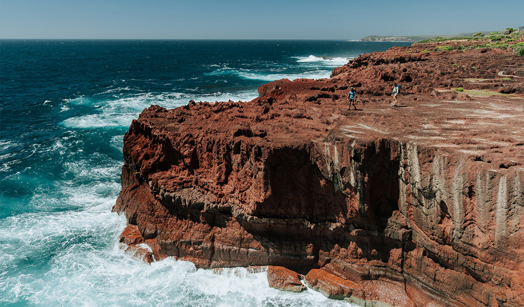 Sea Caves, a large red rock platform along the Light to Light Walk. Credit: Remy Brand/DCCEEW &copy; Remy Brand