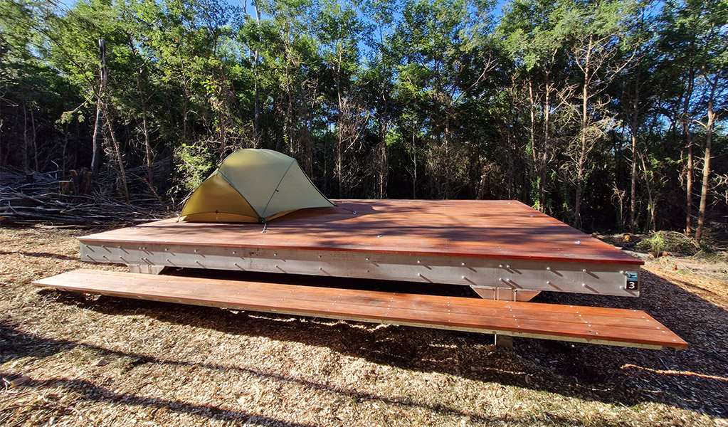 A hardwood tent platform at Hegartys Bay campground. Credit: Sam Doherty &copy; DCCEEW