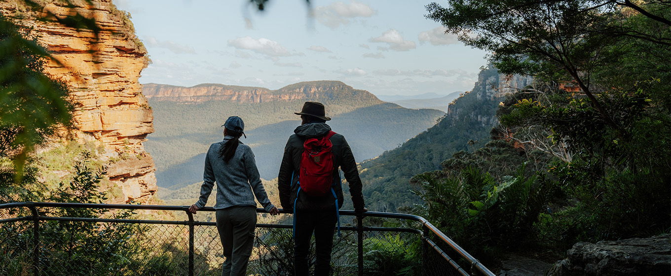 2 walkers admiring the view of Mount Solitary from Leura Falls lookout, on Grand Cliff Top Walk, Blue Mountains National Park. Photo: Remy Brand &copy; Remy Brand