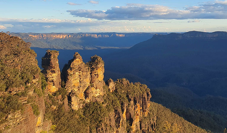 Three Sisters Aboriginal Place at dusk, viewed from Echo Point, with Mount Solitary in the background. Photo: Louise Clifton &copy; DPE
