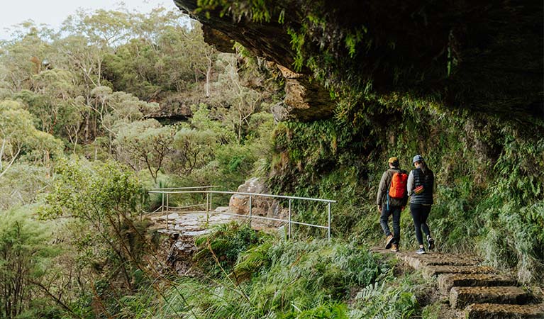 2 walkers following heritage sandstone track on Grand Cliff Top Walk. Photo: Remy Brand &copy; Remy Brand