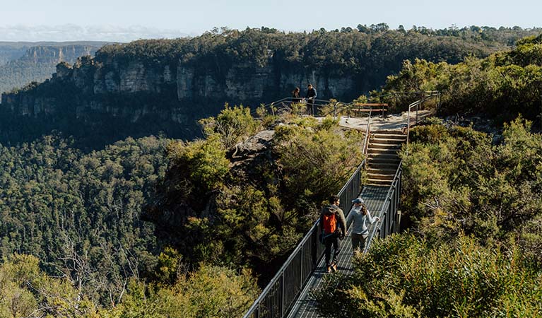 2 walkers crossing Buttenshaw Bridge on Grand Cliff Top Walk. Photo: Remy Brand &copy; Remy Brand