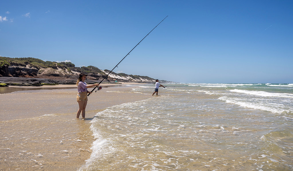 People fishing from the sand at Ten Mile Beach, near Mibanbah-Black Rocks campground. Credit: John Spencer &copy; DCCEEW