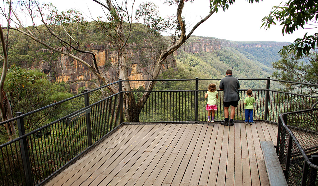 A family at Jersey Lookout, Fitzroy Falls in Morton National Park. Photo: John Yurasek/DCCEEW &copy; DCCEEW