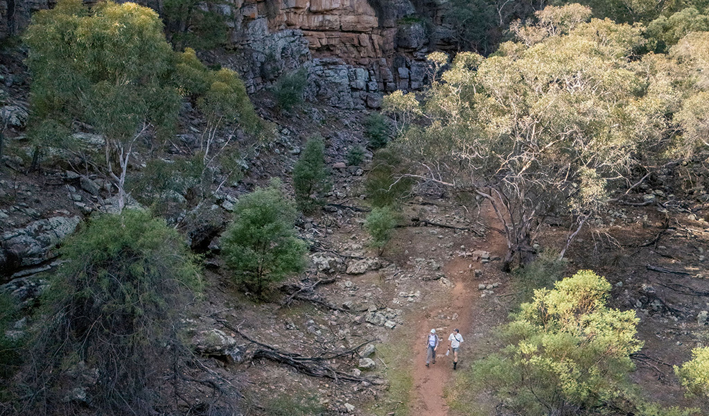 Visitors walk through a sheltered gorge on Jacks Creek walking track in Cocoparra National Park. Credit: John Spencer &copy; DCCEEW