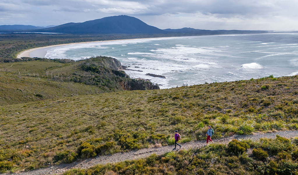 An aerial photo of 2 bushwalkers on Diamond Head loop in Crowdy Bay National Park near Port Macquarie. Credit: John Spencer &copy; DCCEEW