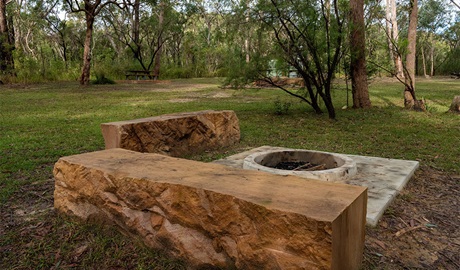 Sandstone seating blocks and fire pit at Ten Mile Hollow campground. Photo: Allan Chawner &copy; DCCEEW