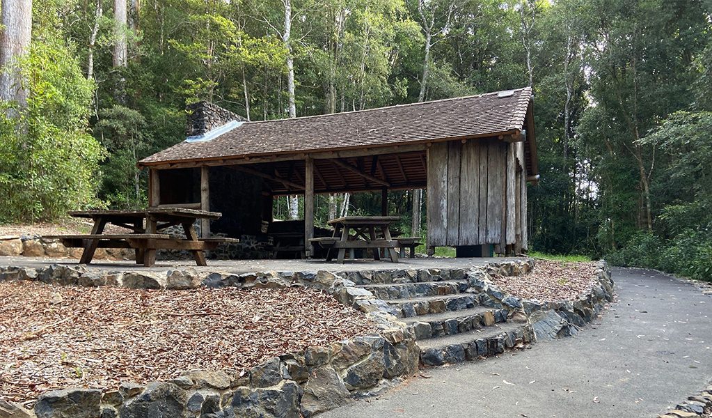 A picnic shelter and table at Never Never picnic area, accessible by stone steps or a concrete path. Credit: Barbara Webster &copy; DCCEEW 