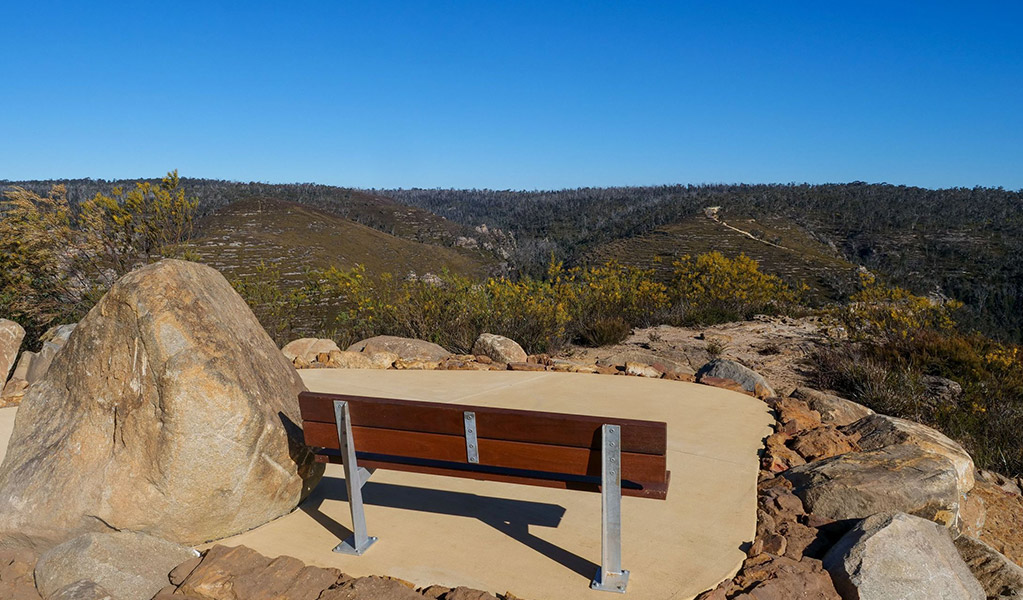 A bench seat on concrete at Lost City North lookout, Gardens of Stone State Conservation Area. Credit: Claudia Abbott &copy; DCCEEW