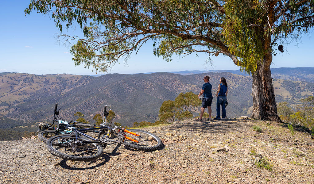 Two visitors enjoying the views at Split Rock lookout. Credit: John Spencer &copy; DCCEEW