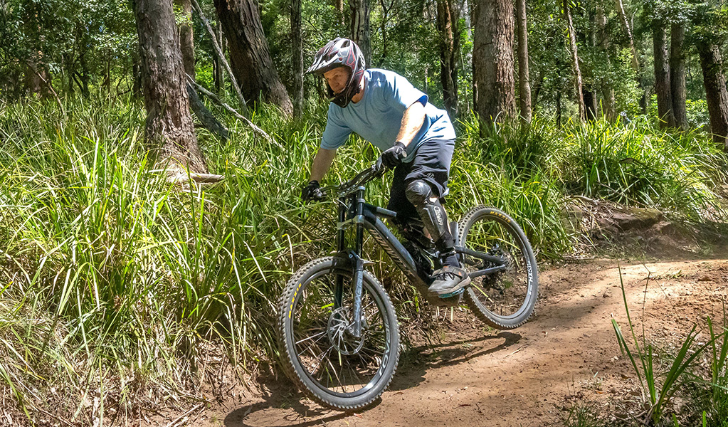 Mountain bike rider wears a full face helmet, gloves, knee protection and closed shoes. Credit: John Spencer &copy; DCCEEW