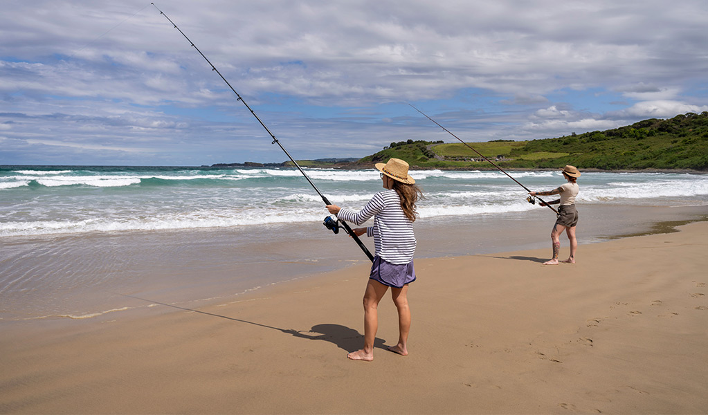 2 people fishing from the sand at Killalea Beach - The Farm. Photo: John Spencer/DCCEEW &copy; DCCEEW