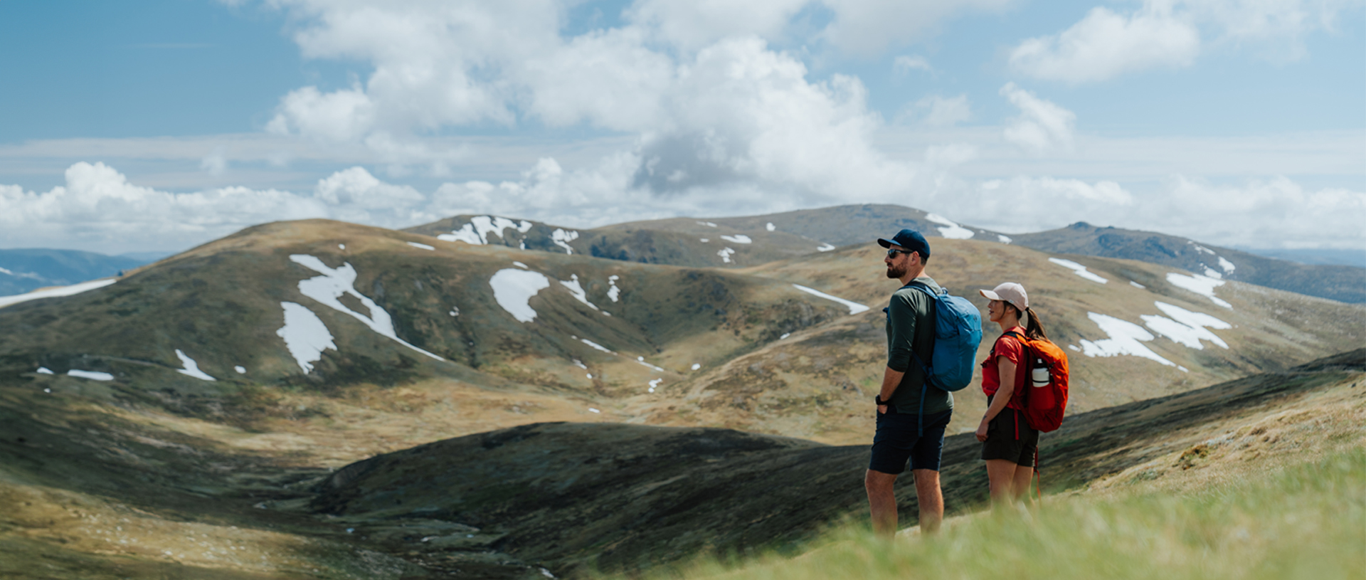 2 hikers admiring snow capped Main Range mountain views on day 2 of Snowies Alpine Walk. Credit: Remy Brand / DCCEEW &copy; Caravel Content