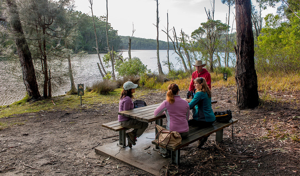 A family resting at a picnic table along Giriwa walking track. Credit: Michael Van Ewijk &copy; DCCEEW