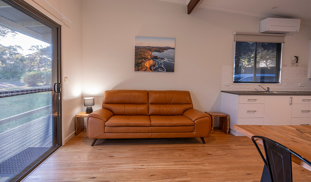 Living area in Depot Beach cabins. Photo: John Spencer &copy; DPIE