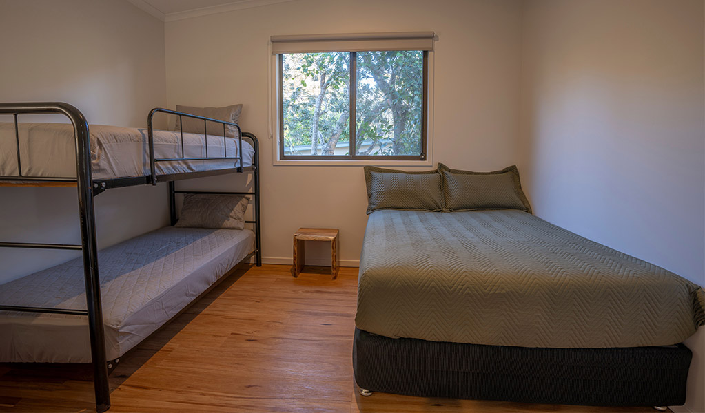 Bedroom with bunk bed in Depot Beach cabins. Photo: John Spencer &copy; DPIE