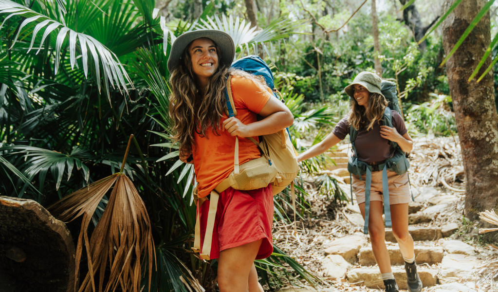 2 bushwalkers descending stairs surrounded by forest on Murramarang South Coast Walk. Credit: Remy Brand &copy; Remy Brand