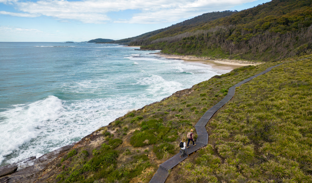 Aerial view of walkers on the formed walking track beside the ocean. Credit: John Spencer &copy; DPE