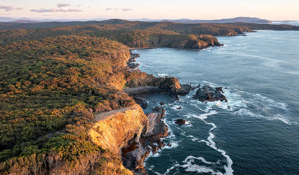 Aerial view of the coastline at sunset, Murramarang National Park. Credit: John Spencer &copy; DPE