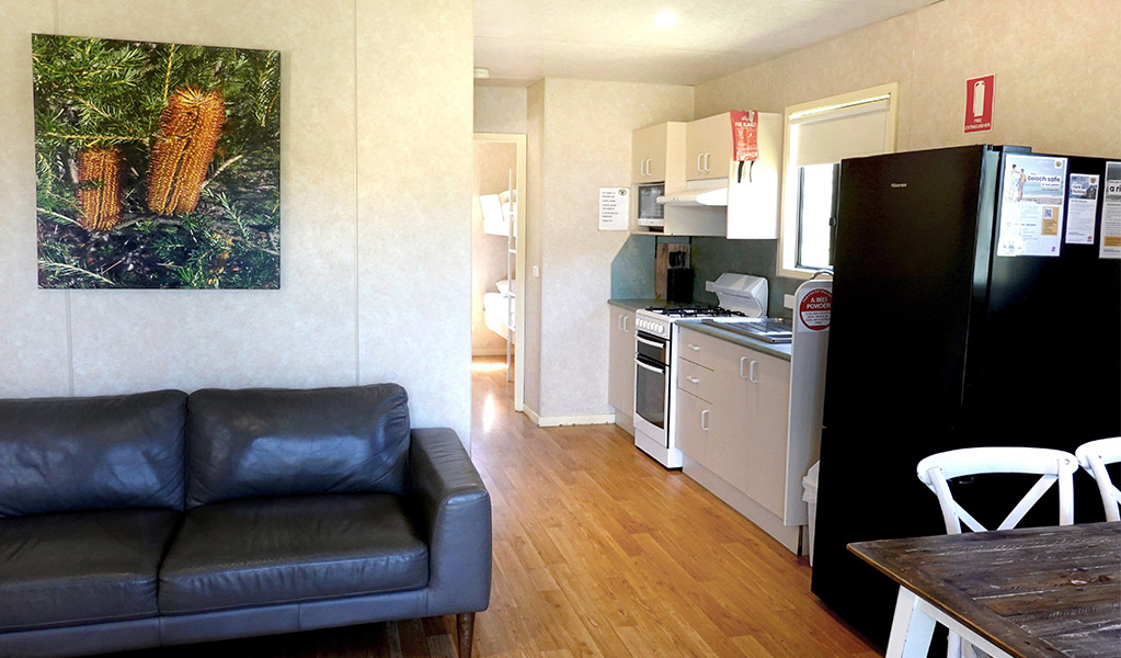 Lounge/dining room, Pretty Beach cabins. Credit: Billy Clare Reitzenstein &copy; DCCEEW