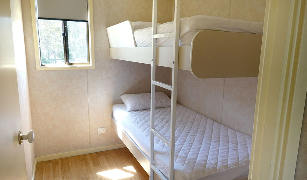 Room with bunk bed, Pretty Beach cabins. Credit: Billy Clare Reitzenstein &copy; DCCEEW