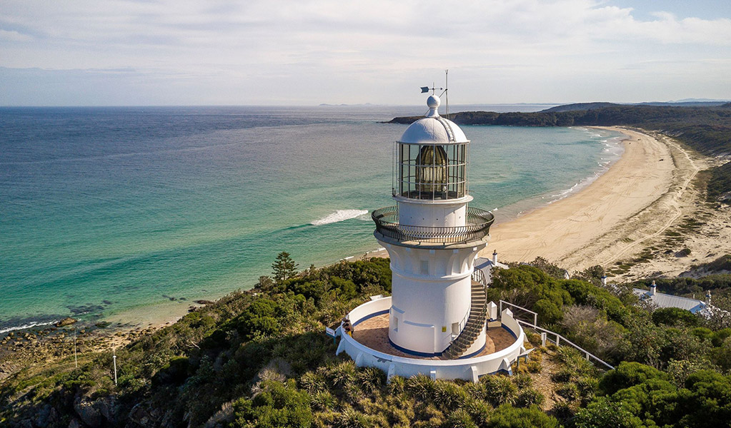 Coastal views from Sugarloaf Point Lighthouse towards Lighthouse Beach. Credit: John Spencer/DCCEEW &copy; DCCEEW