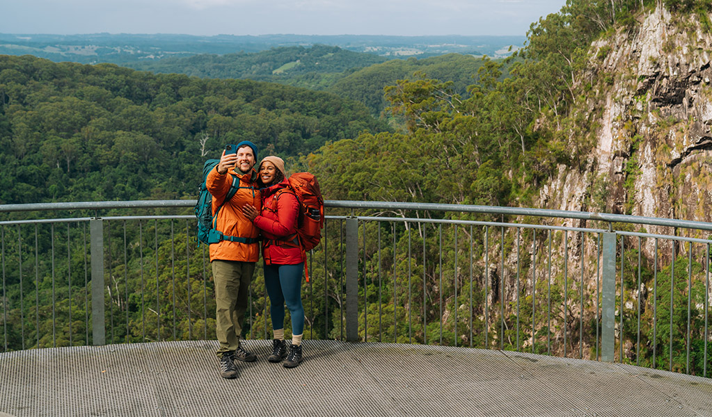 Walkers taking a photo at Minyon Falls lookout. Credit: Remy Brand/DCCEEW &copy; Remy Brand