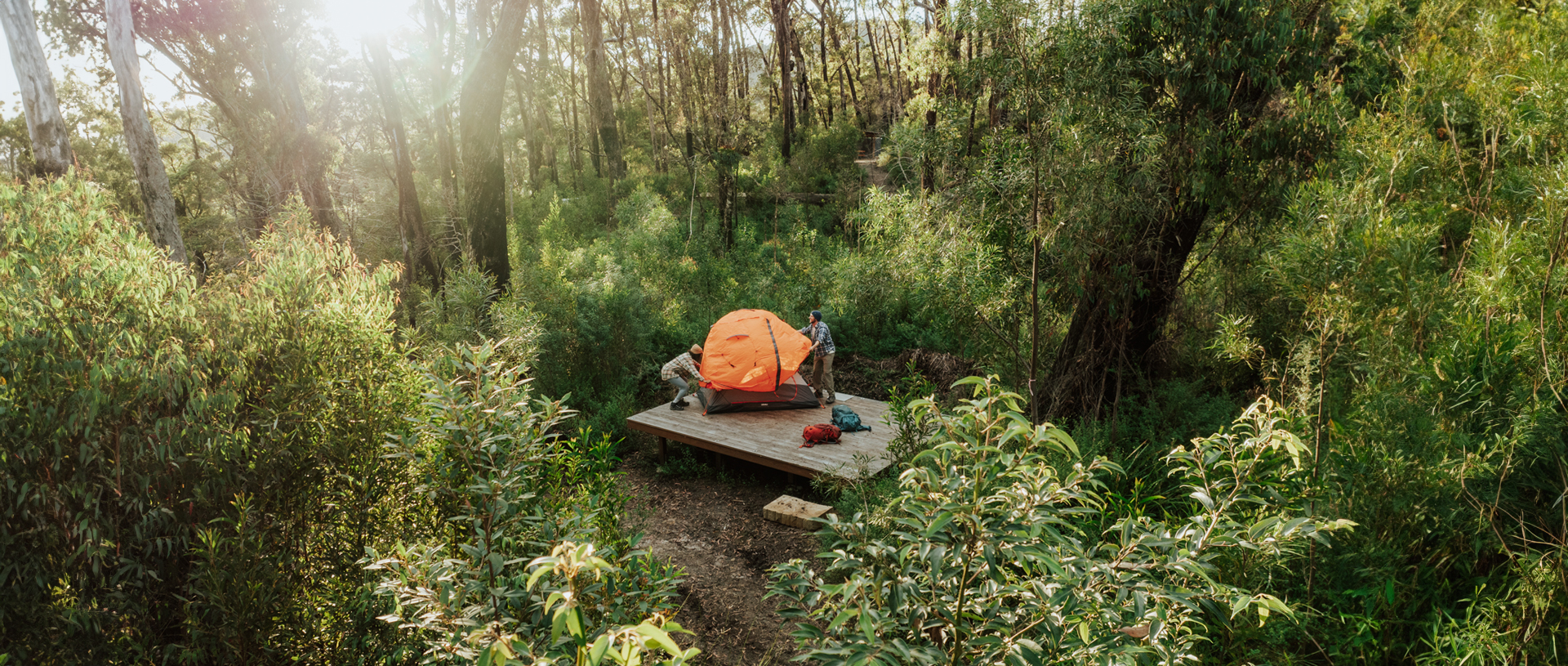 Walkers setting up their tent on the hardwood platform at Sand Ridge campground. Credit: Daniel Parsons/DCCEEW &copy; Daniel Parsons
