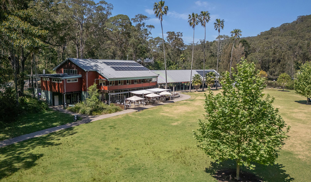 An aerial photo of Royal National Park Visitor Centre next to the historic Audley Dance Hall café and shady picnic areas in Audley Village. Credit: John Spencer &copy; DCCEEW