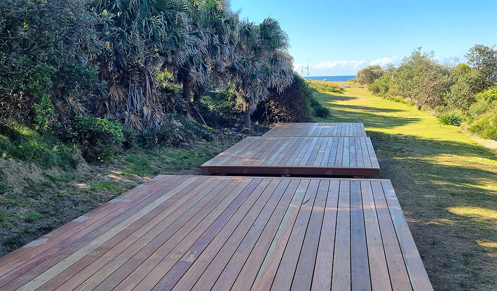 Wooden camping platforms along The Coast track. Credit: Heather Christie &copy; DCCEEW