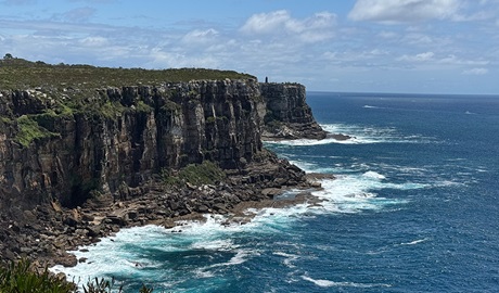 Photo showing tall, sheer cliffs above the ocean and Bluefish Point. Photo credit and &copy; Ingrid Harms