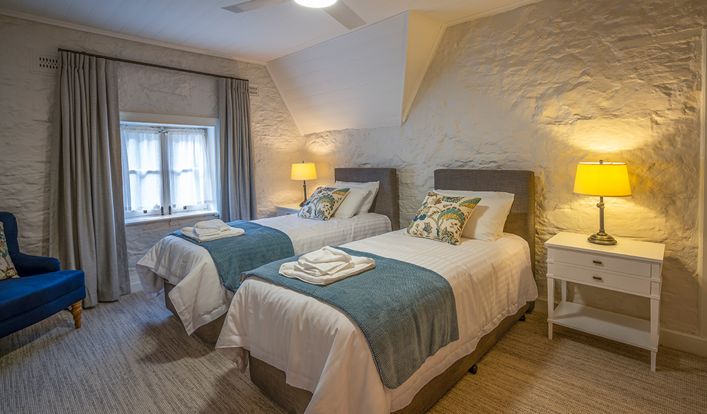 A bedroom with 2 single beds at Gardeners Cottage, Sydney Harbour National Park. Photo:  John Spencer/DPIE