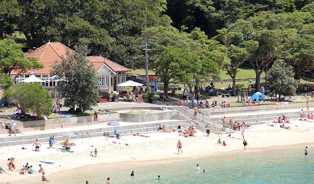 An aerial view of people swimming at Shark Beach, next to Nielsen park picnic area in Sydney Harbour National Park. Credit: John Yurasek © DCCEEW