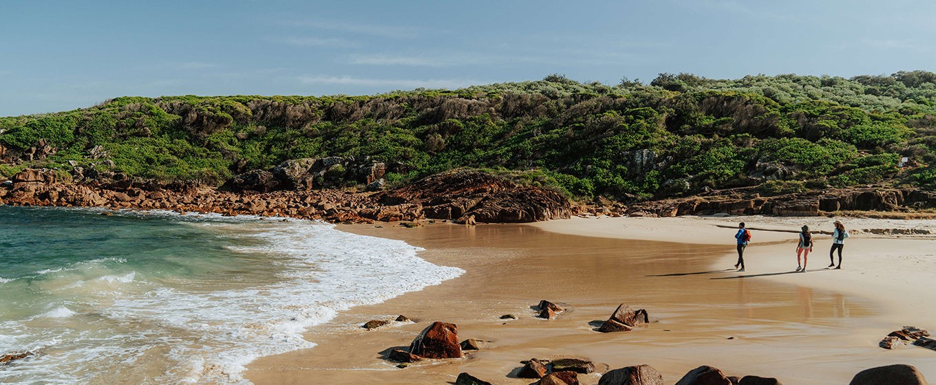 Three walkers cross the sand of Little Kingsley Beach. Credit: Remy Brand &copy; Remy Brand