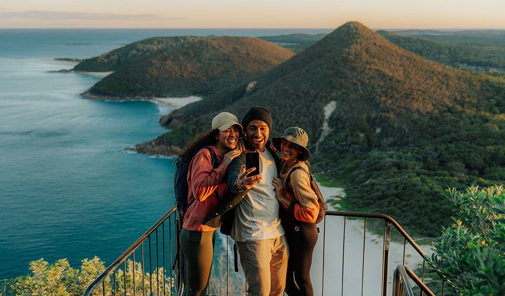 Walkers admire coastal views and islands from the lookout at Tomeree Head Summit. Credit: Remy Brand &copy; Remy Brand