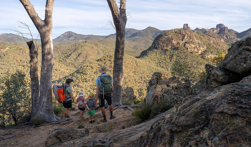 A family with young kids enjoying views of the volcanic landscape along Fans Horizon walking track. Credit: John Spencer &copy; DCCEEW